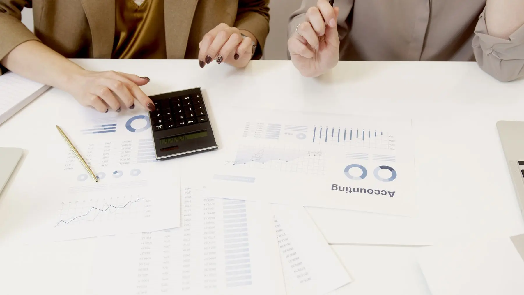 Hesap makinesi ve raporlarla finansal analiz yapan uzmanlar